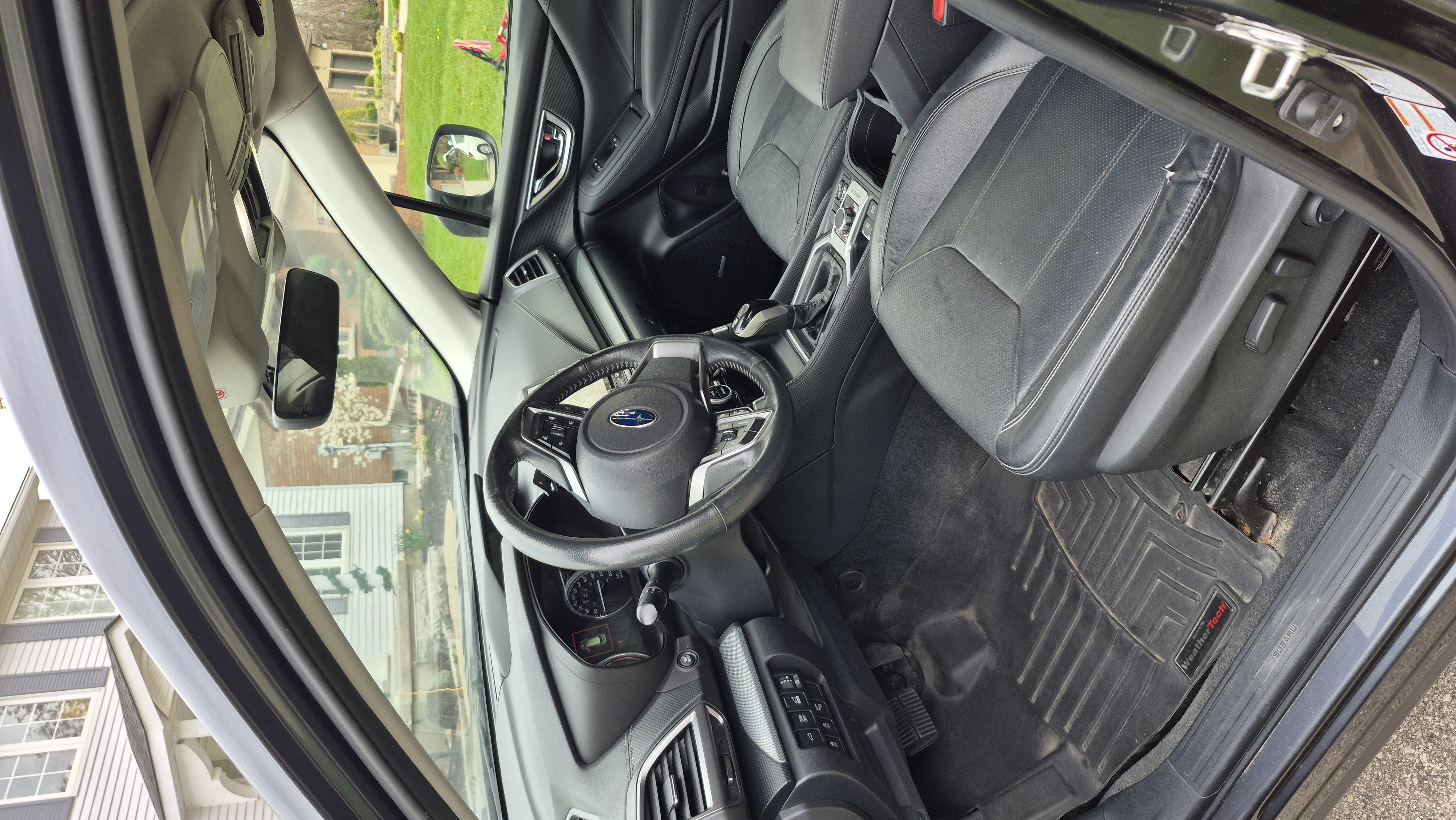 Car interior after detailing — clean glossy dashboard and pristine seats in bright showroom lighting