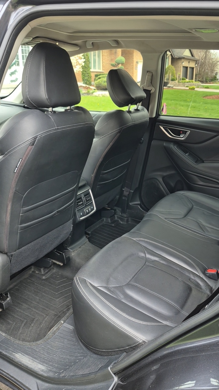 Gleaming car exterior after detail — mirror-like paint reflection under bright showroom lights