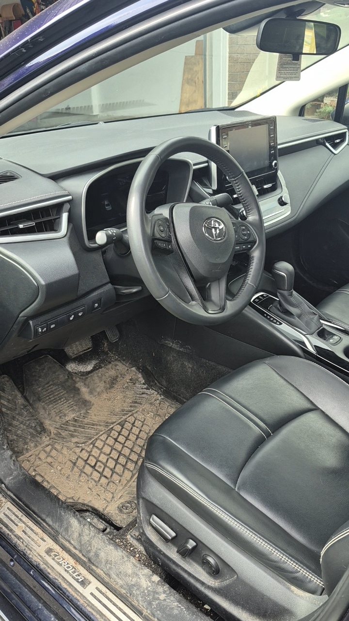 Rear seat area before detailing — dirty fabric seats with stains and debris